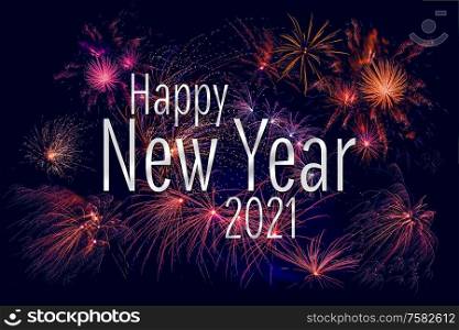 Happy New Year 2021 greeting with colorful fireworks in the night sky