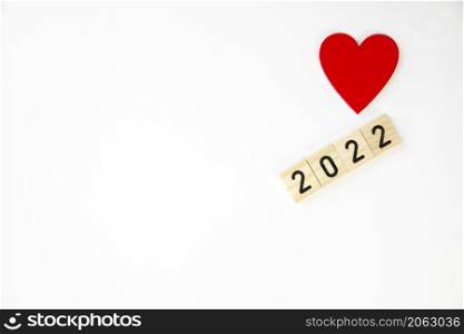 Happy new year 2022 on white background, red color heart , Copy Space, top view. space for text. Happy new year 2022 on white background, red color heart , Copy Space, top view.