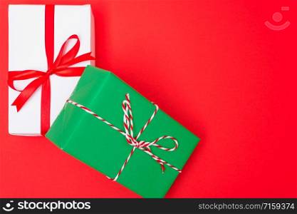 Happy New Year and Christmas 2020 day, top view Xmas white and green gift boxes on red background with copy space for your text