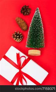 Happy New Year and Christmas 2020 day, top view Xmas white gift boxes & fir tree on red background with copy space for your text