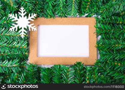 Happy New Year and Christmas day, top view flat lay composition decoration branches tree photo frame on white background with copy space for your text