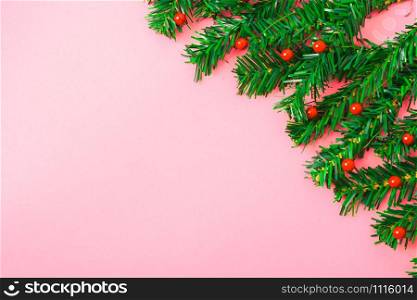 Happy New Year and Christmas day, top view flat lay composition decoration tree fir branch on pink background with copy space for your text