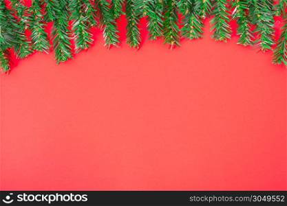 Happy New Year and Christmas day, top view flat lay composition decoration tree fir on red background with copy space for your text