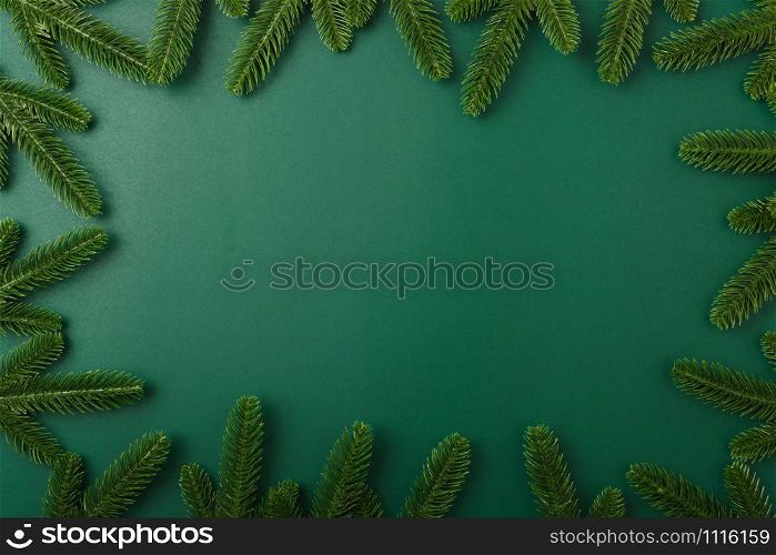 Happy new year, christmas day concept top view flat lay fir tree branches on Olive Green background with copy space for your text