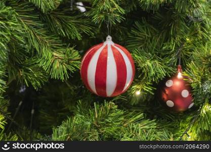 Happy New Year Christmas tree decorates on background bokeh of side flickering light bulbs garlands for family holiday.