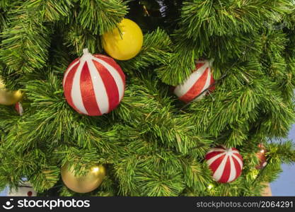 Happy New Year Christmas tree decorates on background bokeh of side flickering light bulbs garlands for family holiday.