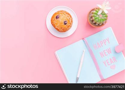 Happy New Year concept, workspace desk styled design office supplies and cactus on pink pastel background minimal style