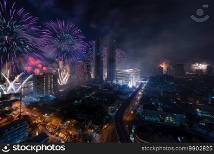 Happy New Year Fireworks Festival Event Icon Siam. Aerial view of Bangkok Downtown Skyline, Thailand. Financial district and business centers in smart urban city in Asia. Skyscraper building at night.