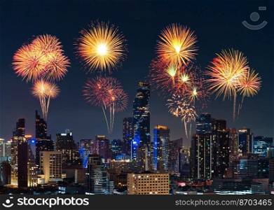 happy new year fireworks over buildings cityscape at night in Bangkok city, Thailand 