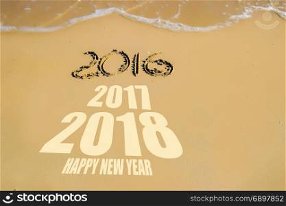 Happy new year for 2018 on the sand background