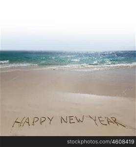 Happy new year on beach. Happy new year handwriting on tropical sea beach