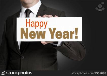 Happy New Year sign held by businessman concept.. Happy New Year sign held by businessman concept