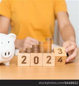 Happy New Year with piggy bank and flipping 2023 change to 2024 block. Resolution, Goals, Plan, Action, Money Saving, Retirement fund, Pension, Investment and Financial concept