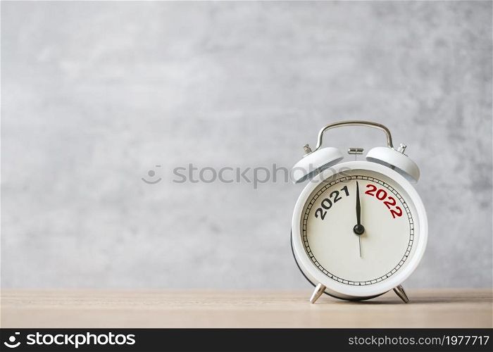 Happy New Year with vintage alarm clock and 2021 change to 2022 number. Merry Christmas, New Start, Resolution, countdown, Goals, Plan, Action and Mission Concept