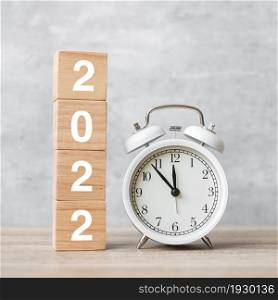 Happy New Year with vintage alarm clock and 2022 block. Christmas, New Start, Resolution, countdown, Goals, Plan, Action and Motivation Concept