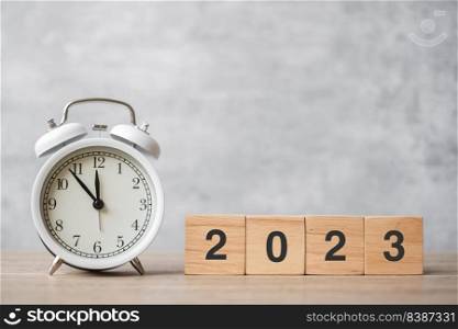 Happy New Year with vintage alarm clock and 2023 block. Christmas, New Start, Resolution, countdown, Goals, Plan, Action and Motivation Concept