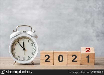 Happy New Year with vintage alarm clock and flipping 2021 change to 2022 block. Christmas, New Start, Resolution, countdown, Goals, Plan, Action and Motivation Concept