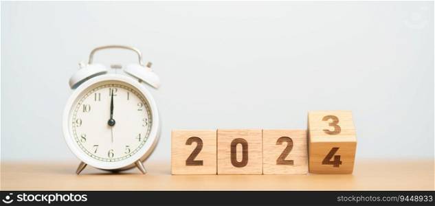 Happy New Year with vintage alarm clock and flipping 2023 change to 2024 block. Christmas, New Start, Resolution, countdown, Goals, Plan, Action and Motivation Concept