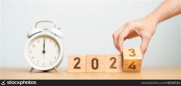 Happy New Year with vintage alarm clock and flipping 2023 change to 2024 block. Christmas, New Start, Resolution, countdown, Goals, Plan, Action and Motivation Concept