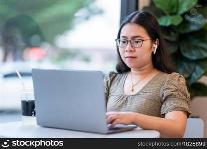 Happy of asian freelance people business female casual working with laptop computer with coffee cup and smartphone in coffee shop like the background,communication concept