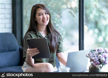 Happy of asian freelance people business female casual working with laptop computer and using tablet with coffee cup and smartphone in coffee shop like the background,communication concept