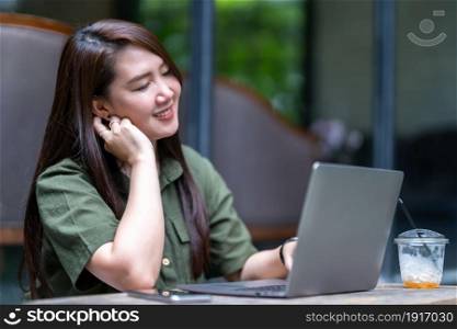 Happy of beautiful asian freelance people business female casual working with laptop computer with coffee cup and smartphone in coffee shop like the background,communication concept