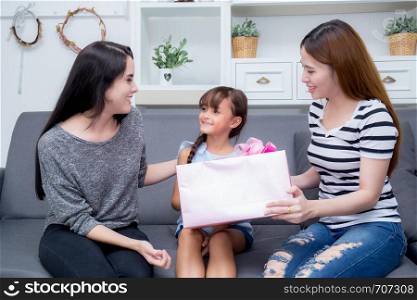happy of mother and daughter woman asian and aunt with gift with pink ribbon and daughter kissing mother, Happy family concept. Happy mother's day.