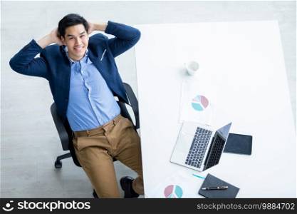 Happy of successful asian young businessman on laptop computer, tablet with blank touch screen isolated and Pen on notebook on White wooden table background in office top view 