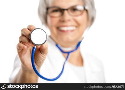 Happy old female doctor holding a stethoscope, isolated on white