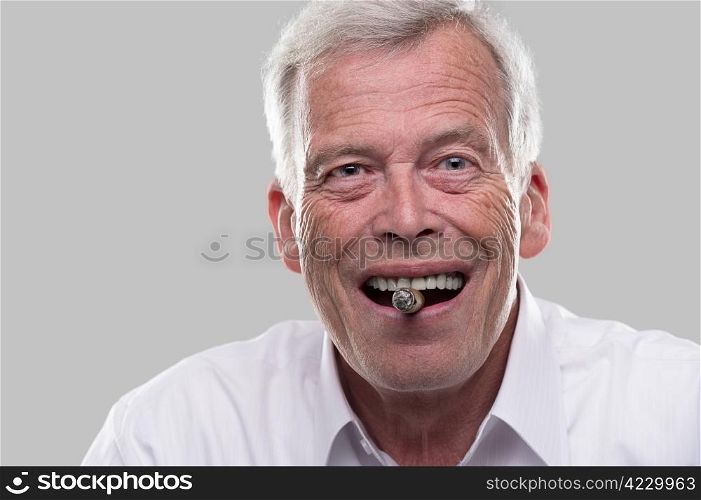 Happy old man with a cigar in his mouth and a big smile.