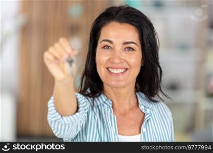 happy older woman showing key