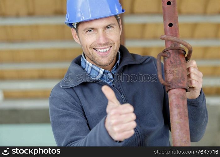 happy onstruction worker with pipe