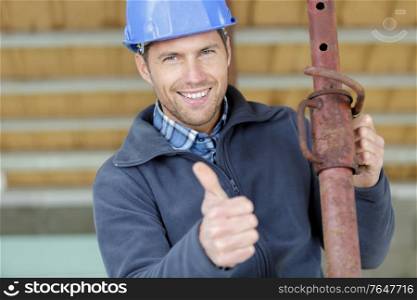 happy onstruction worker with pipe
