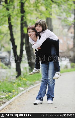 happy oung mother and daughter have fun outdoor