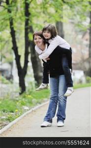 happy oung mother and daughter have fun outdoor