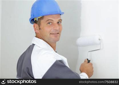 happy painter holding painting roller