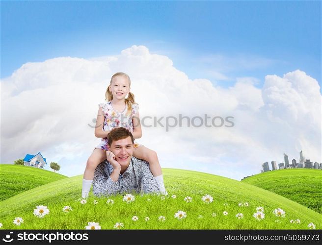 Happy parenting. Happy family of father and daughter lying on green grass