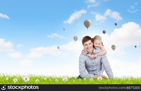 Happy parenting. Happy family of father and daughter sitting on grass