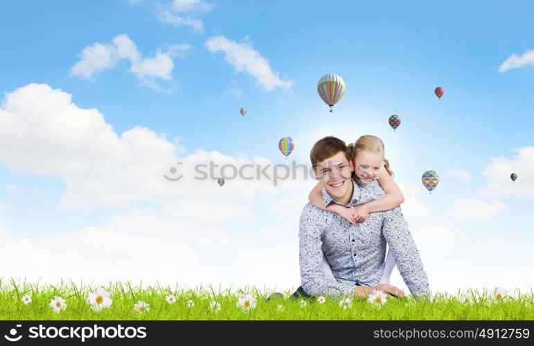 Happy parenting. Happy family of father and daughter sitting on grass