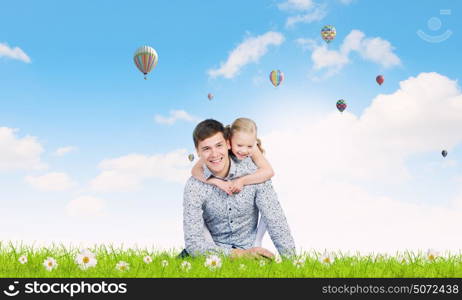 Happy parenting. Happy family of father and daughter sitting on grass