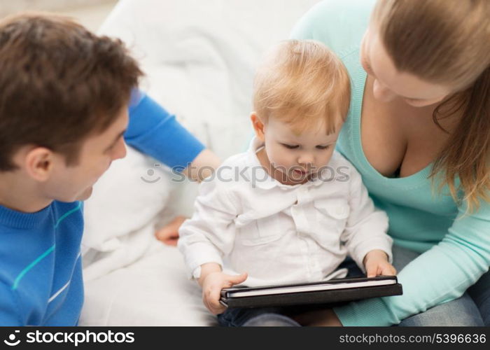 happy parents and adorable baby with tablet pc