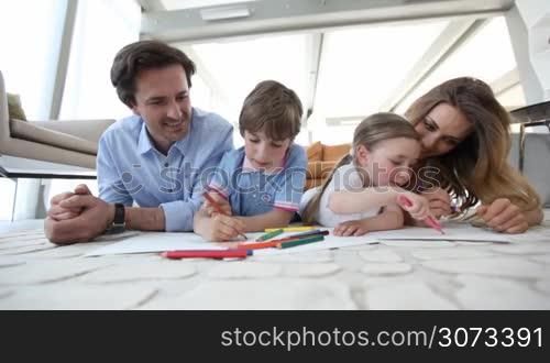 Happy parents drawing with their children