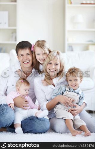 Happy parents with three children at home