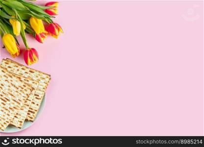 Happy Passover banner. Matzo and a bouquet of colorful tulips on pink background. Traditional Jewish food for Pesach. Copy space.. Happy Passover banner. Matzo and a bouquet of colorful tulips on a pink background. Traditional Jewish food for Pesach. Copy space.
