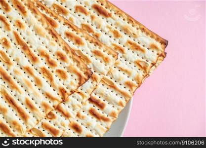 Happy Passover. Matzo on pink background. Traditional Jewish food for regilious spring holiday of Pesach.. Happy Passover. Matzo on a pink background. Traditional Jewish food for regilious spring holiday of Pesach.
