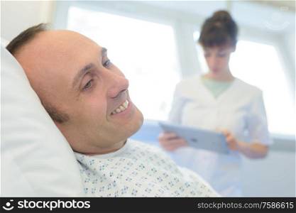 happy patient lying on hospital bed