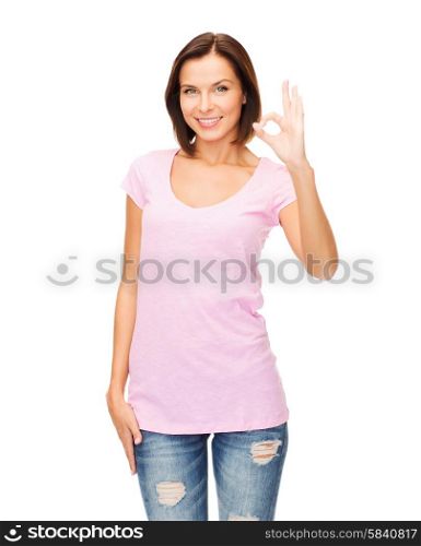 happy people concept - smiling woman in blank pink t-shirt showing ok gesture. woman in blank pink t-shirt showing ok gesture