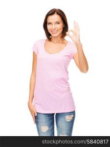 happy people concept - smiling woman in blank pink t-shirt showing ok gesture. woman in blank pink t-shirt showing ok gesture