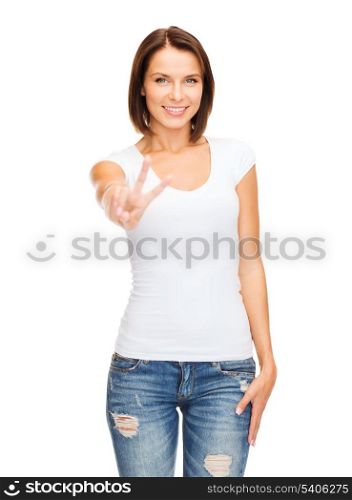 happy people concept - young smiling woman showing victory or peace sign
