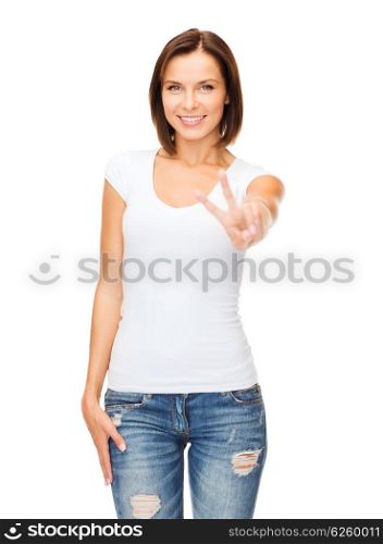 happy people concept - young smiling woman showing victory or peace sign. woman showing victory or peace sign